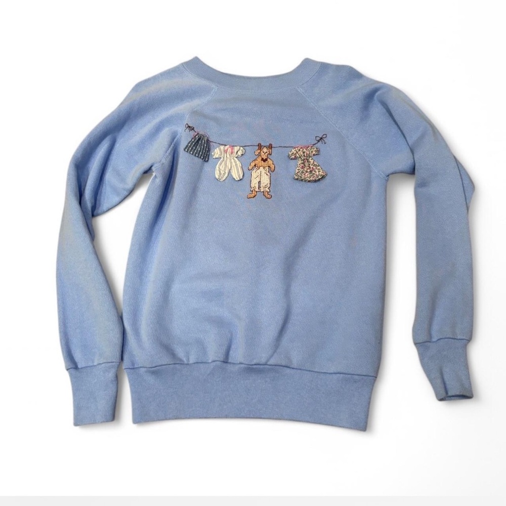 Blue Sweatshirt with Embroidered Clothesline Design